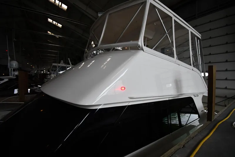 Slide: The Image of 1996 Viking 50 Convertible yacht docked in a dimly lit marina. - 2