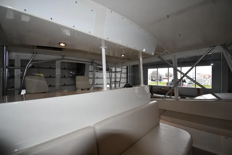 Slide: The Image of Interior view of a 1996 Viking 50 Convertible yacht, showcasing seating and windows. - 20