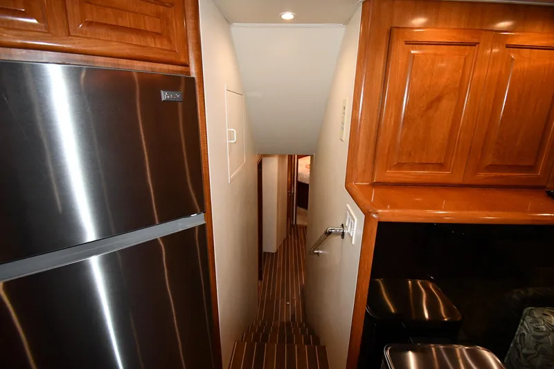 Slide: The Image of Interior of 1996 Viking 50 Convertible yacht with wooden cabinets and stainless steel appliances. - 25