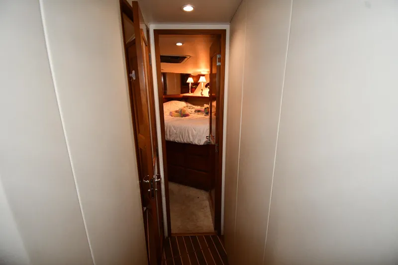 Slide: The Image of Hallway leading to cozy bedroom on 1996 Viking 50 Convertible yacht. - 26