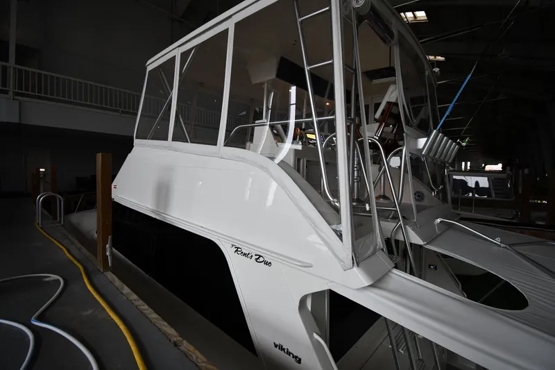 Slide: The Image of 1996 Viking 50 Convertible yacht docked indoors, showcasing sleek design and structure. - 3