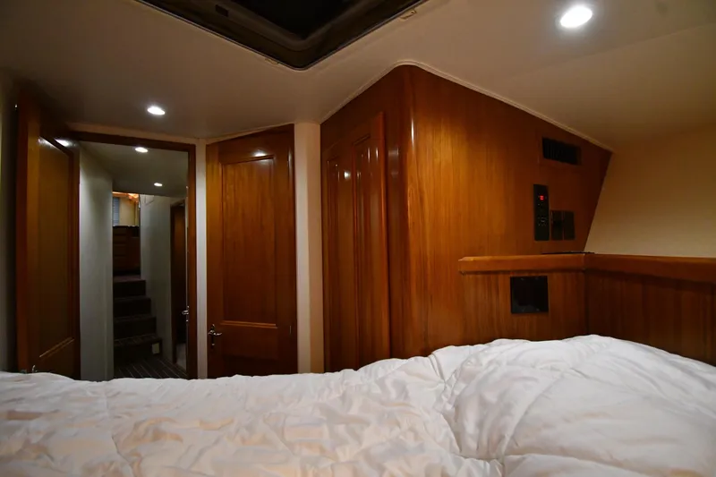 Slide: The Image of Cozy cabin interior of 1996 Viking 50 Convertible yacht with wood paneling and soft lighting. - 30