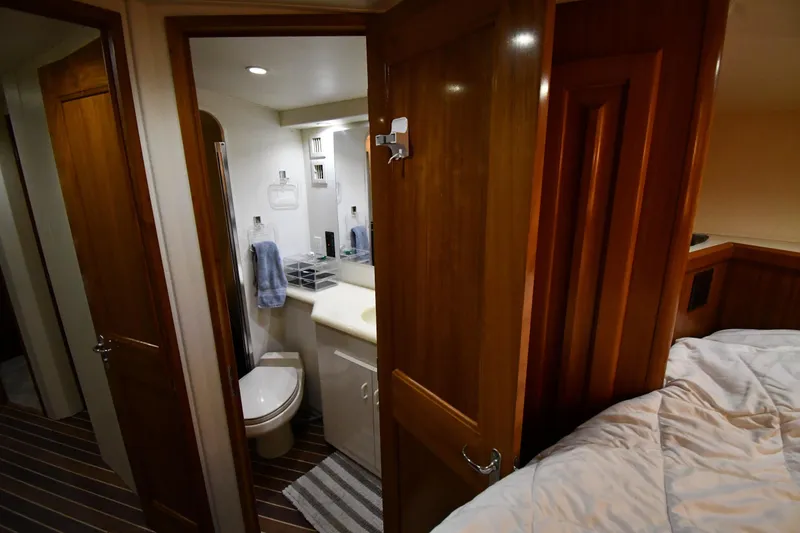 Slide: The Image of Interior of 1996 Viking 50 Convertible yacht showing bathroom and bedroom. - 32