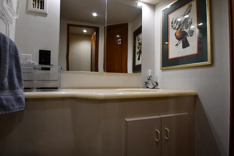 Slide: The Image of Bathroom interior of 1996 Viking 50 Convertible yacht with artwork and modern fixtures. - 34