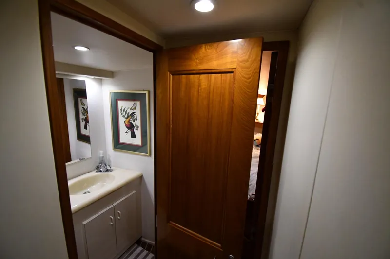 Slide: The Image of Bathroom interior of 1996 Viking 50 Convertible yacht with wooden door and framed artwork. - 35