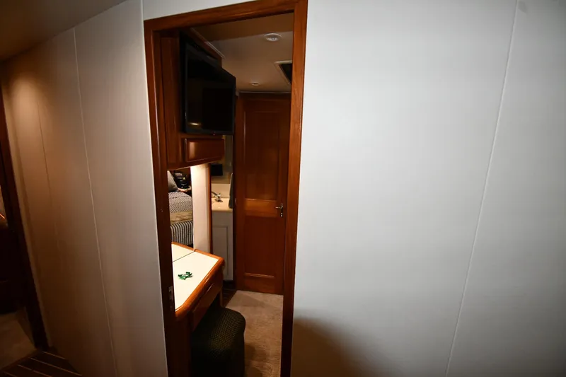 Slide: The Image of Interior of 1996 Viking 50 Convertible yacht, featuring a cozy cabin with wooden accents. - 38