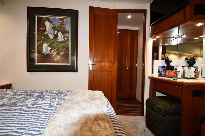 Slide: The Image of Interior of 1996 Viking 50 Convertible yacht with cozy bedroom and elegant decor. - 40