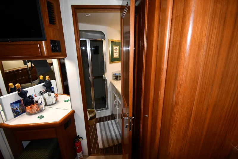 Slide: The Image of Interior of 1996 Viking 50 Convertible yacht with wooden cabinetry and bathroom view. - 44