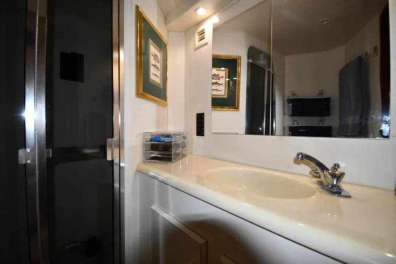 Slide: The Image of Bathroom interior of 1996 Viking 50 Convertible yacht with sink and mirror. - 45