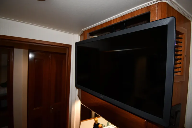 Slide: The Image of Flat-screen TV mounted in a 1996 Viking 50 Convertible yacht interior. - 47