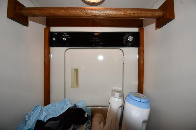 Slide: The Image of Laundry area on a 1996 Viking 50 Convertible boat with dryer and supplies. - 48