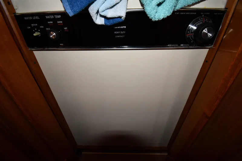 Slide: The Image of 1996 Viking 50 Convertible interior with laundry controls and towels. - 49