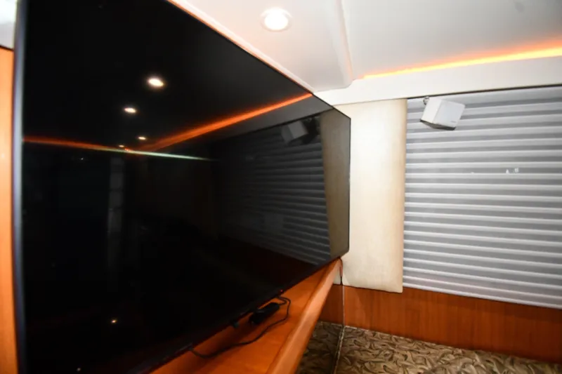 Slide: The Image of Interior of 1996 Viking 50 Convertible yacht with modern TV and ambient lighting. - 60