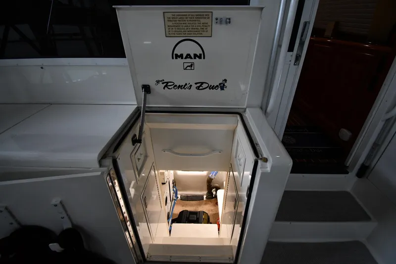 Slide: The Image of Engine room access on 1996 Viking 50 Convertible yacht, featuring MAN engine branding. - 61