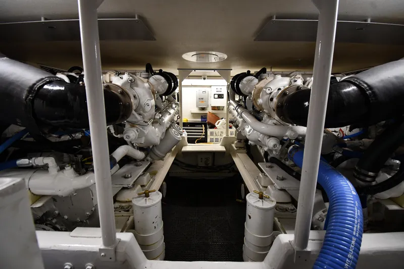 Slide: The Image of Engine room of a 1996 Viking 50 Convertible yacht, showcasing dual engines and mechanical components. - 62