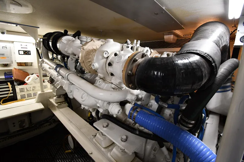 Slide: The Image of Engine room of a 1996 Viking 50 Convertible yacht, showcasing detailed machinery and components. - 63