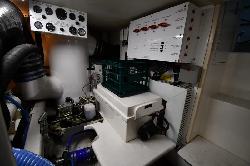 Slide: The Image of Engine room of 1996 Viking 50 Convertible yacht with control panels and equipment. - 64