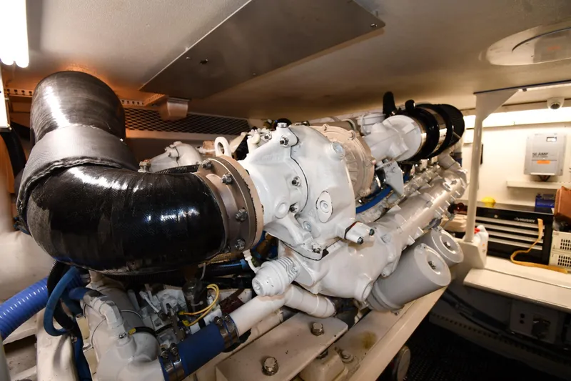 Slide: The Image of Engine room of a 1996 Viking 50 Convertible yacht, showcasing detailed machinery. - 65