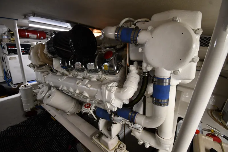Slide: The Image of Engine room of a 1996 Viking 50 Convertible yacht, showcasing detailed machinery. - 70