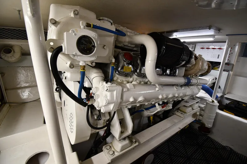 Slide: The Image of Engine room of a 1996 Viking 50 Convertible yacht, showcasing detailed machinery. - 71