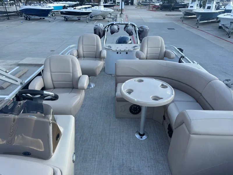 Slide: The Image of 2017 Avalon LSZ rf 2285 pontoon boat interior with beige seating and table. - 18