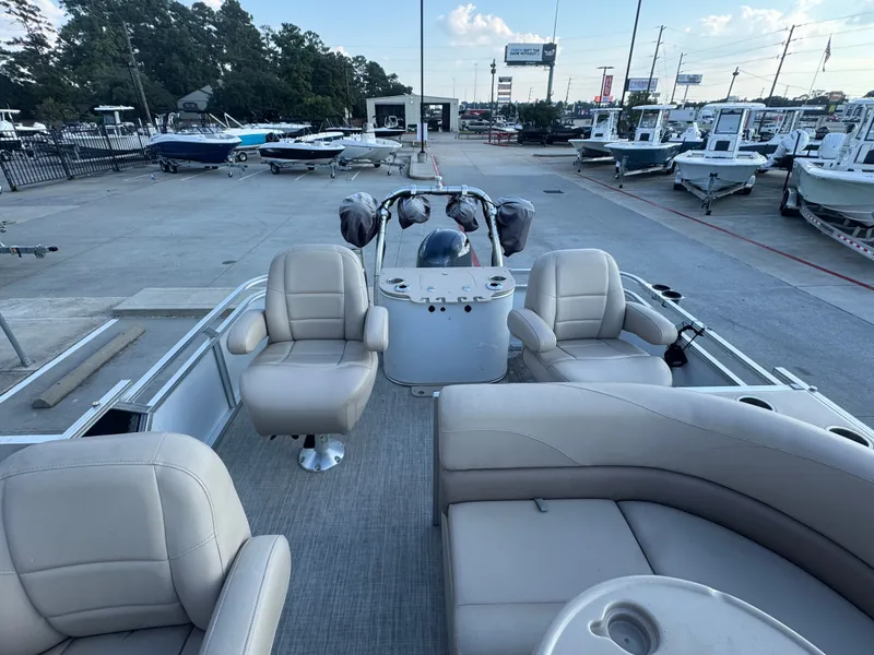 Slide: The Image of 2017 Avalon LSZ rf 2285 pontoon boat with beige seating, displayed at a dealership. - 23