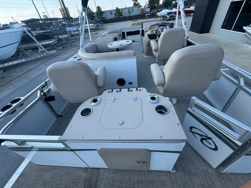 Slide: The Image of 2017 Avalon LSZ rf 2285 pontoon boat interior with beige seating and steering console. - 28