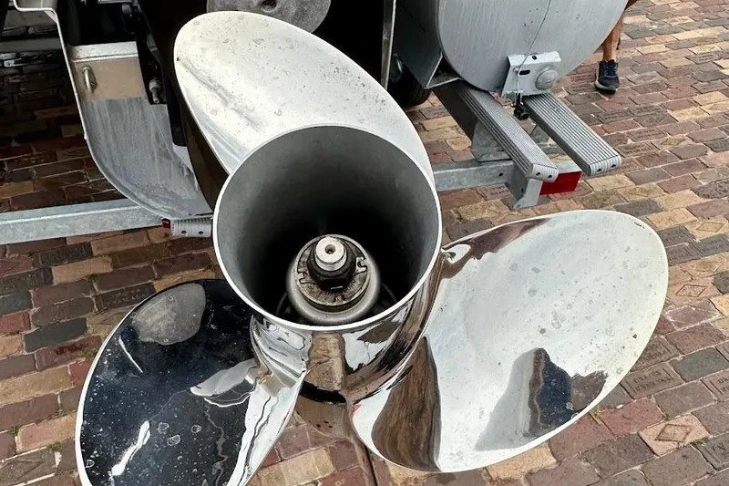 Slide: The Image of Close-up of a shiny boat propeller on a 2023 Harris 230 Cruiser. - 11
