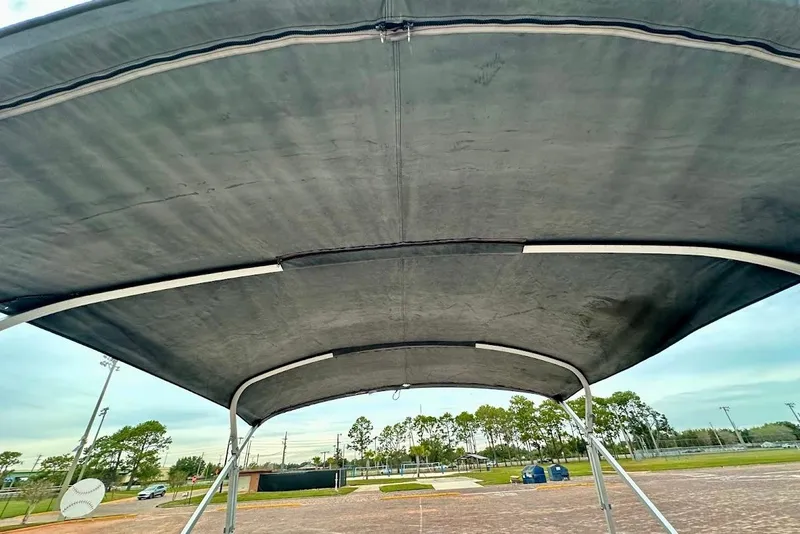 Slide: The Image of Bimini top of 2023 Harris 230 CRUISER boat, viewed from below, outdoors. - 24
