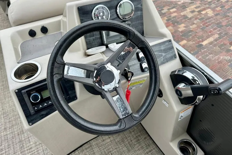 Slide: The Image of Steering console of 2023 Harris 230 Cruiser boat with controls and gauges. - 25
