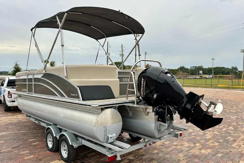 Slide: The Image of 2023 Harris 230 Cruiser pontoon boat on trailer with outboard motor. - 3