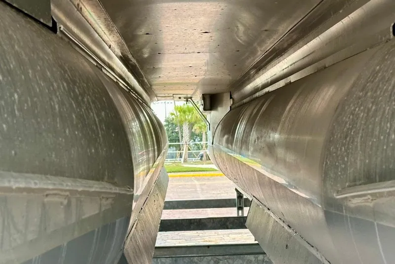 Slide: The Image of Underneath view of a 2023 Harris 230 CRUISER pontoon boat, showcasing aluminum pontoons. - 6