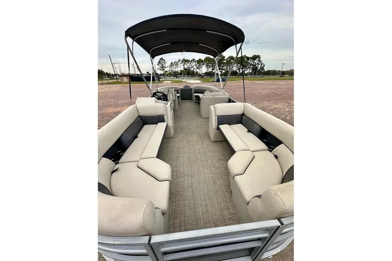 Slide: The Image of 2023 Harris 230 Cruiser pontoon boat with spacious seating and canopy. - 7