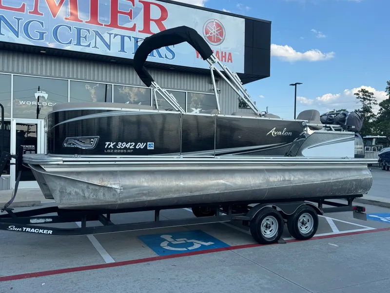 Slide: The Image of 2017 Avalon LSZ rf 2285 pontoon boat on trailer at dealership. - 1
