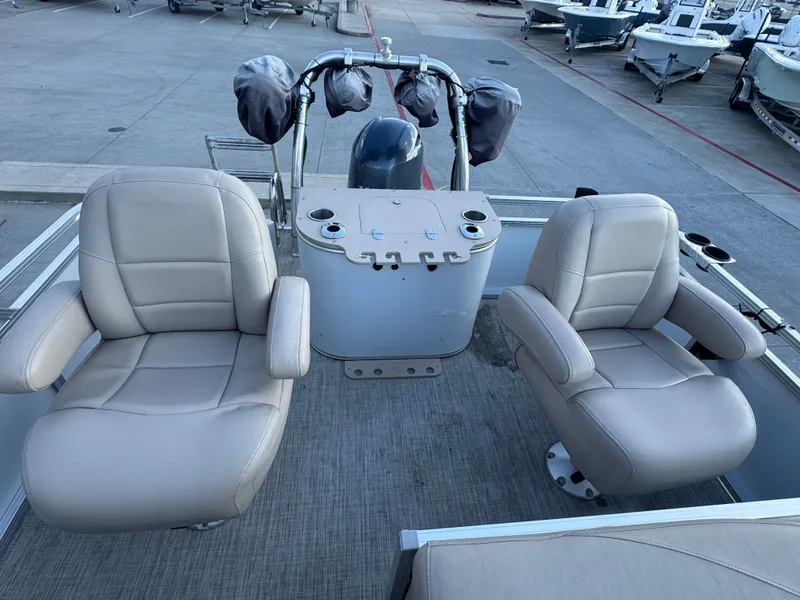 Slide: The Image of 2017 Avalon LSZ rf 2285 boat interior with two beige captain chairs and control console. - 26
