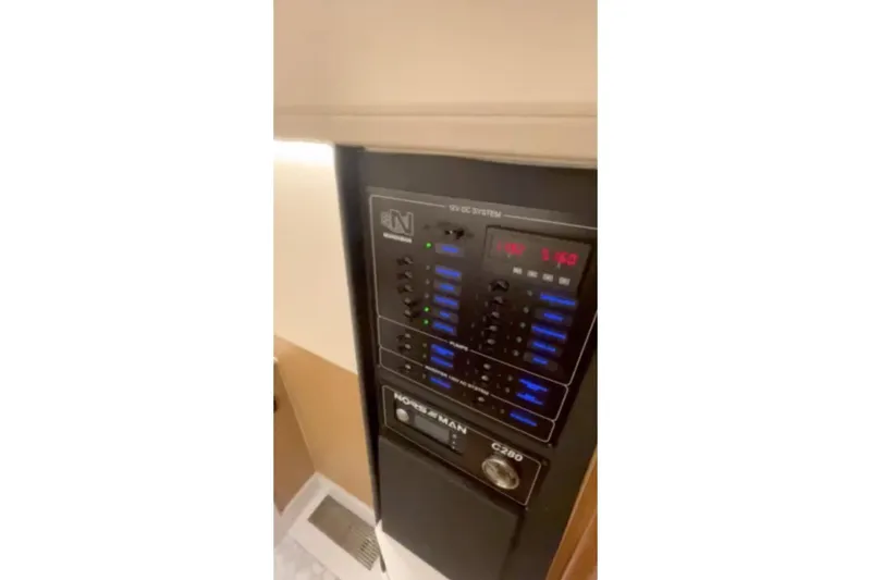 Slide: The Image of Control panel of 2025 Norseman C280 Center Console boat, featuring digital displays and switches. - 11