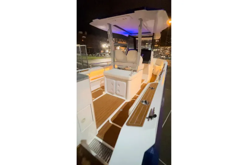 Slide: The Image of 2025 Norseman C280 Center Console boat with illuminated deck at night. - 6