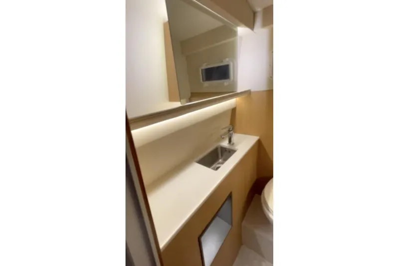 Slide: The Image of 2025 Norseman C280 Center Console bathroom with modern sink and mirror. - 8