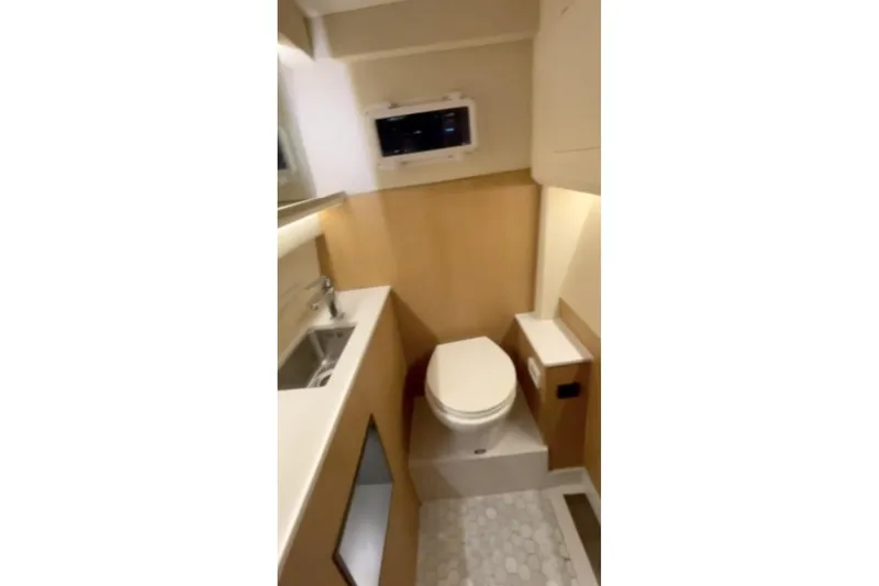 Slide: The Image of 2025 Norseman C280 Center Console boat interior with compact bathroom amenities. - 9