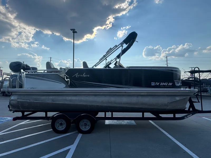 Slide: The Image of 2017 Avalon LSZ rf 2285 pontoon boat on trailer under cloudy sky. - 3