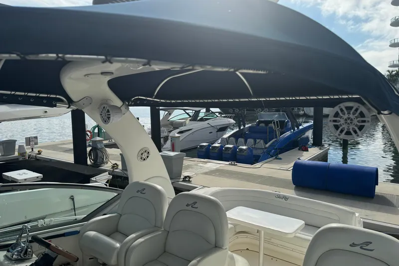 Slide: The Image of 2008 Sea Ray 340 Sundancer docked, featuring spacious seating and canopy. - 18