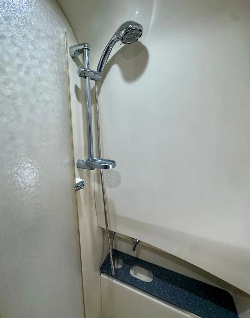 Slide: The Image of Shower area in a 2006 Formula 40pc boat, featuring a sleek chrome showerhead. - 22