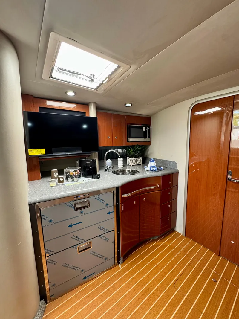 Slide: The Image of 2006 Formula 40pc yacht interior with kitchenette, wooden flooring, and modern amenities. - 28