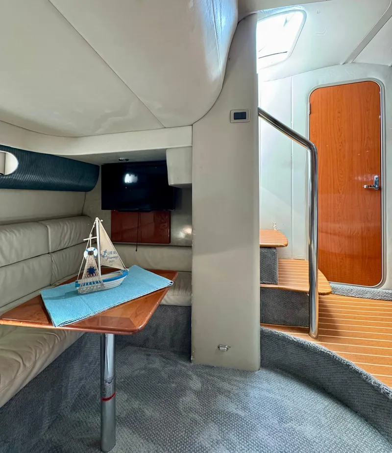 Slide: The Image of Interior of a 2006 Formula 40pc yacht with cozy seating and wooden accents. - 32
