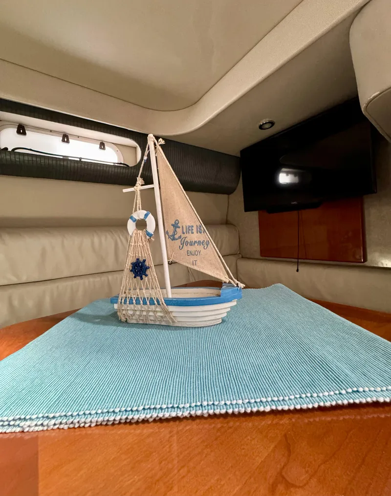 Slide: The Image of Interior of 2006 Formula 40pc yacht with decorative sailboat on table. - 34