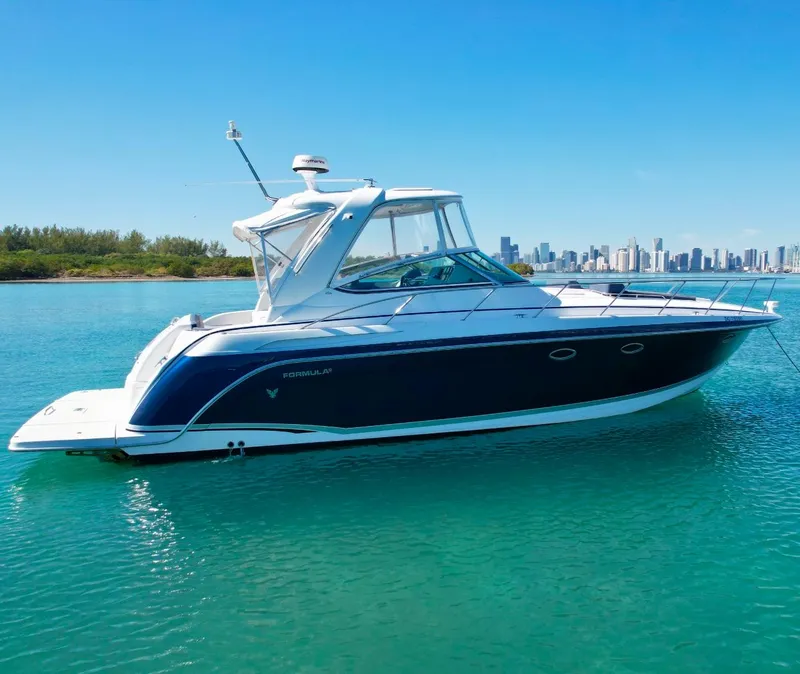 Slide: The Image of 2006 Formula 40pc yacht on clear water with city skyline in background. - 5