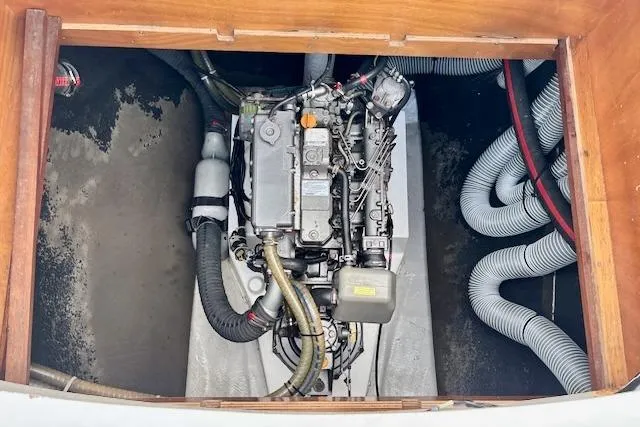 Slide: The Image of 2013 Lagoon 450 catamaran docked at marina with dinghy and American flag. - 10