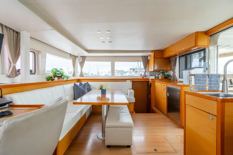 Slide: The Image of Luxurious interior of 2013 Lagoon 450 yacht with modern kitchen and dining area. - 100