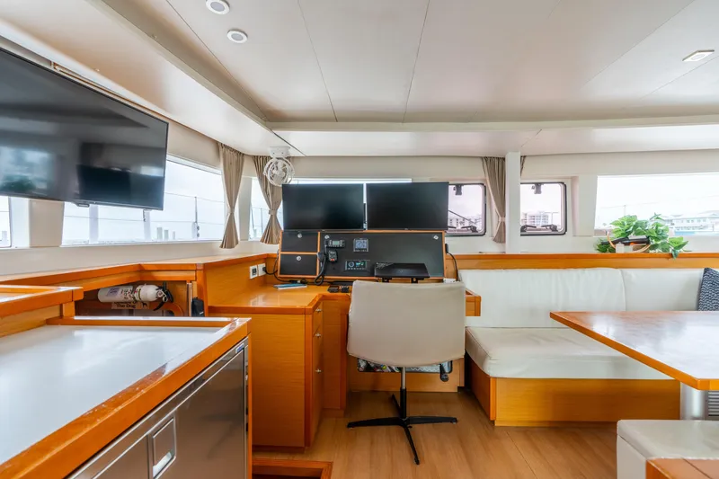 Slide: The Image of Interior of 2013 Lagoon 450 yacht with modern navigation station and seating area. - 101