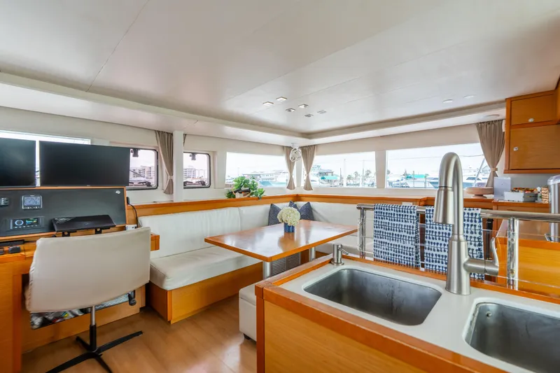 Slide: The Image of Luxurious interior of 2013 Lagoon 450 catamaran with modern kitchen and seating area. - 102